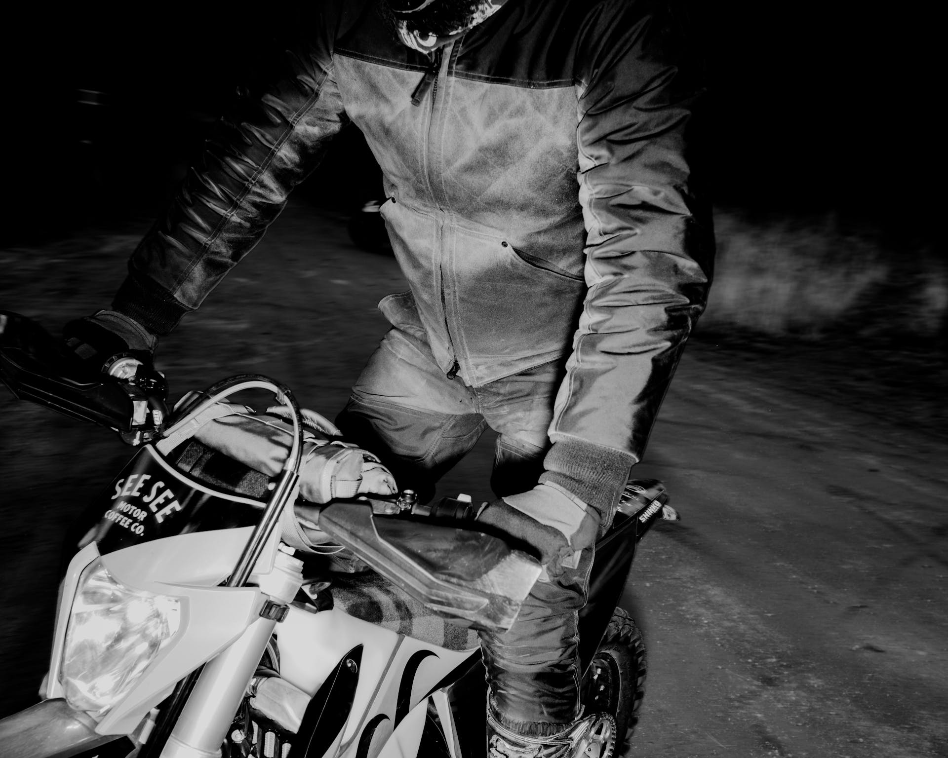 Man wearing Filson Alcan Quilted Jacket in cinder riding on a motorcycle