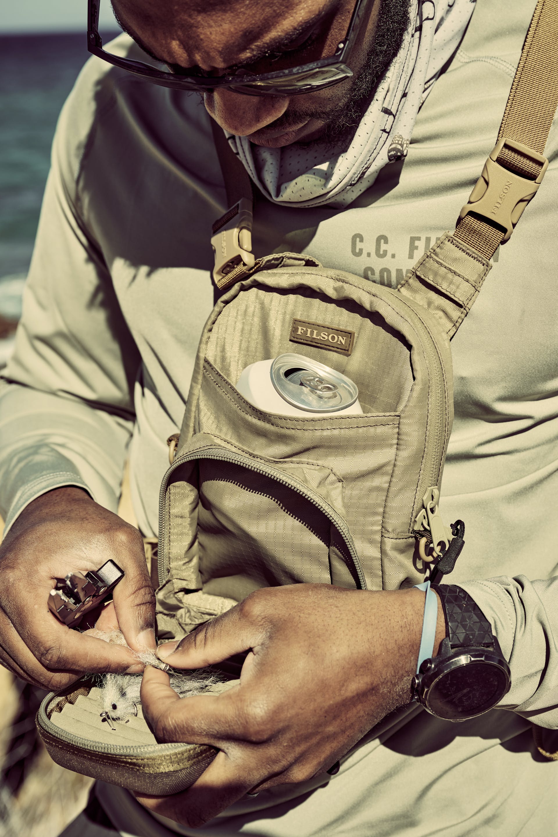 Fisherman working with tackle wearing a Filson Long Sleeve Barrier T-Shirt