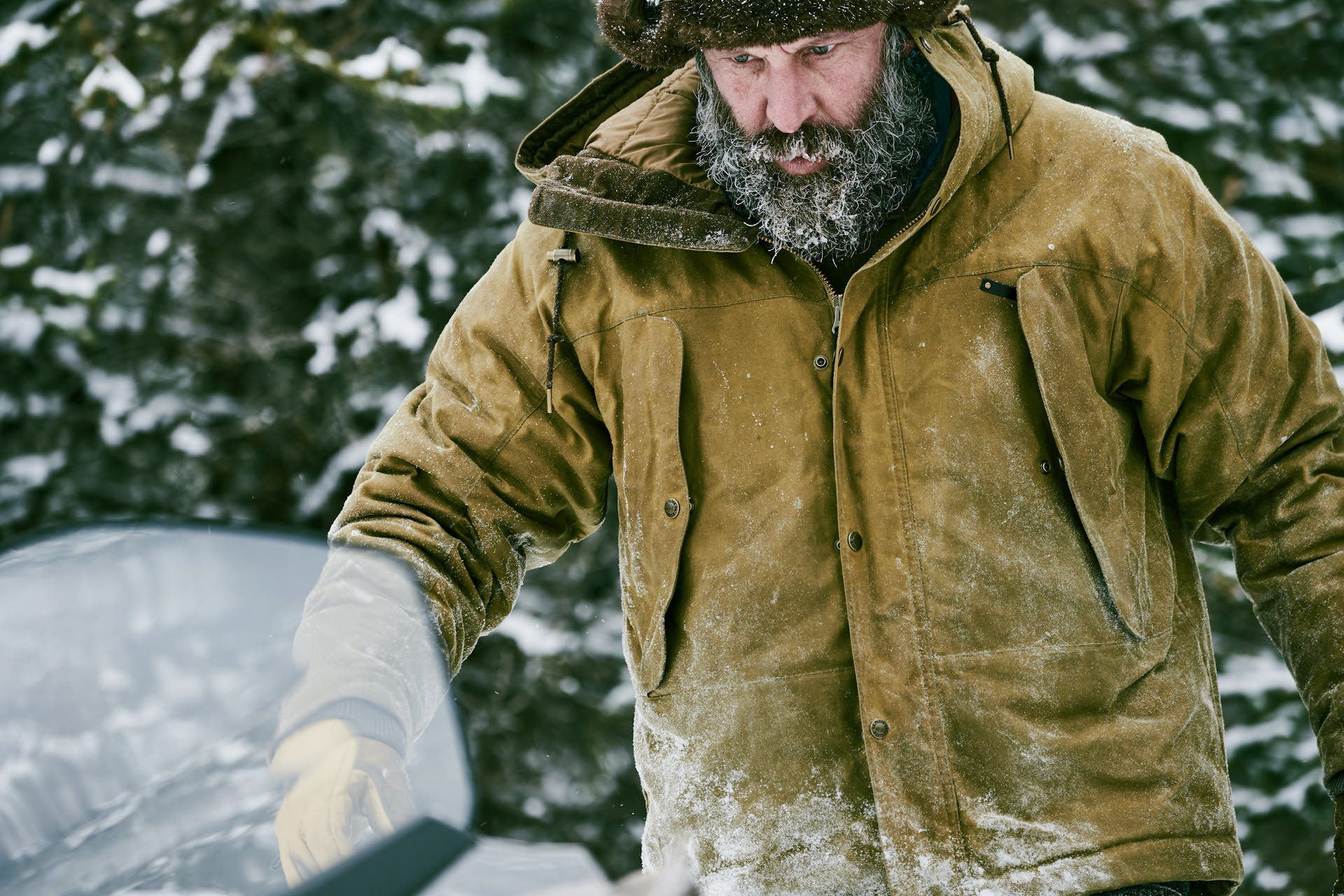 Man walking through the snow wearing a Filson Insulated Shelter Cloth Parka